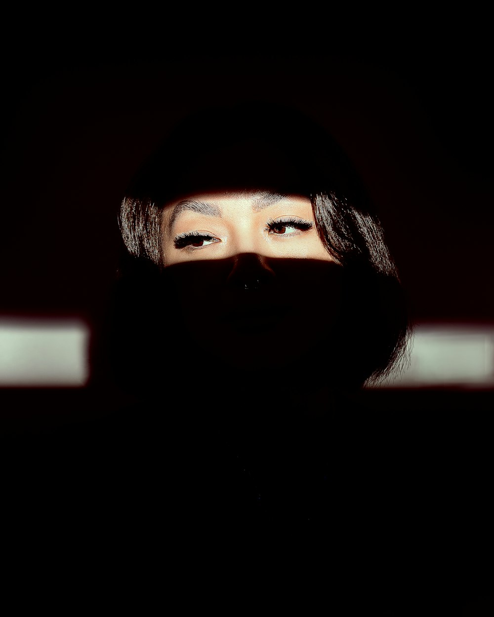 a woman with a black veil covering her face