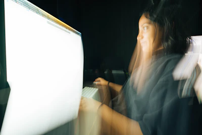 Subtle motion blur of a focused individual organizing digital workflows on a laptop.