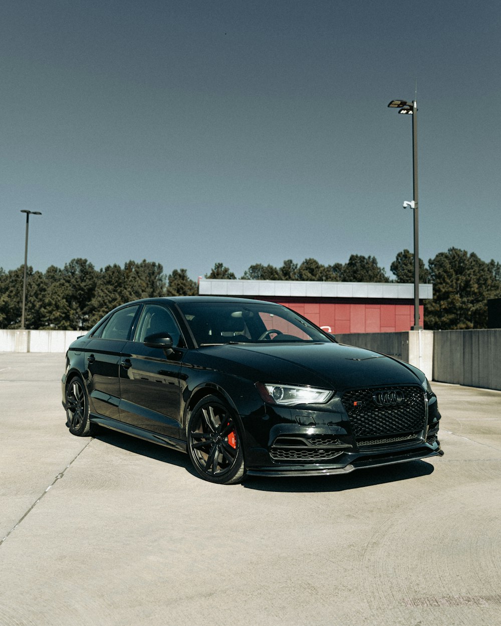 a black car parked in a parking lot