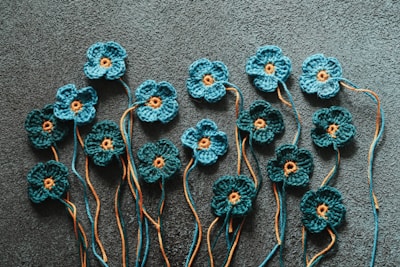 a group of crocheted flowers sitting on top of a carpet
