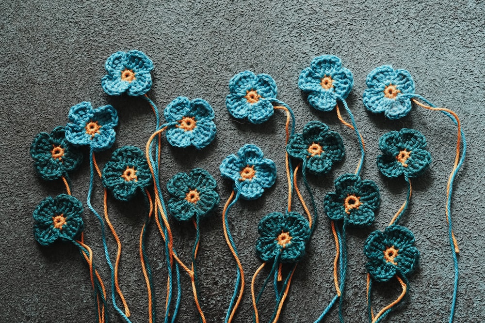 a group of crocheted flowers sitting on top of a carpet