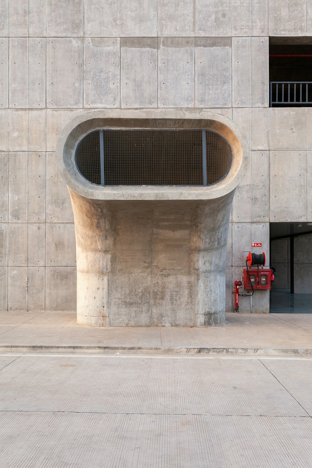 a red fire hydrant sitting in front of a building