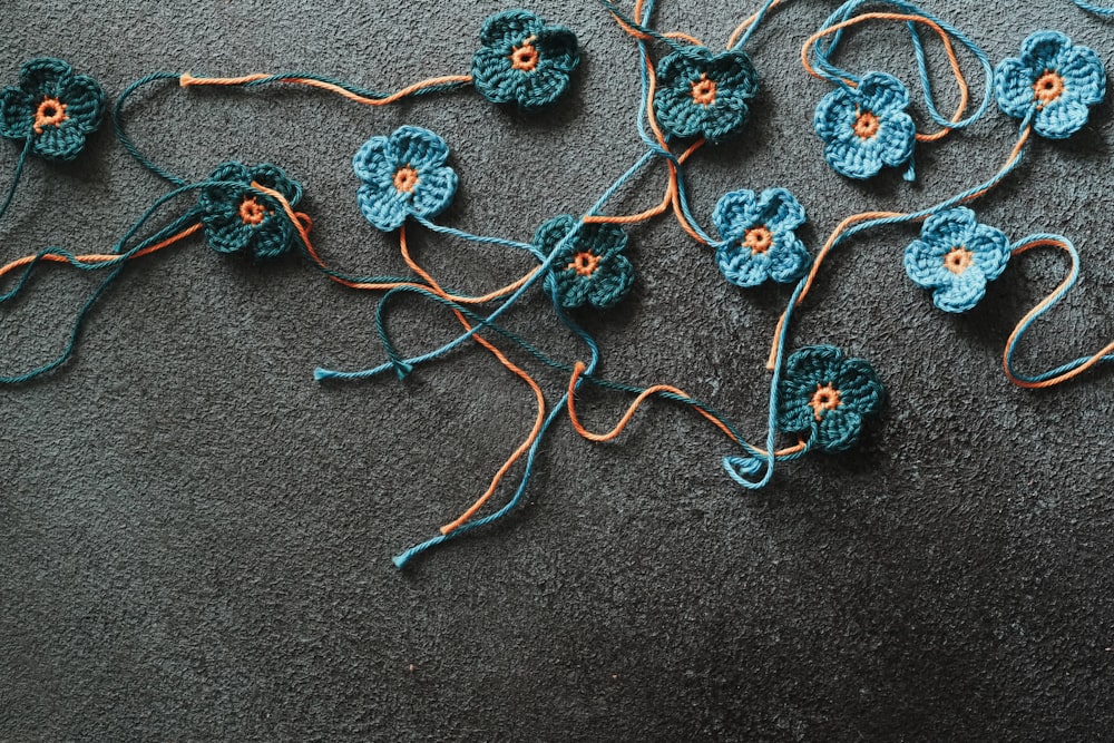 a group of crocheted flowers laying on the ground