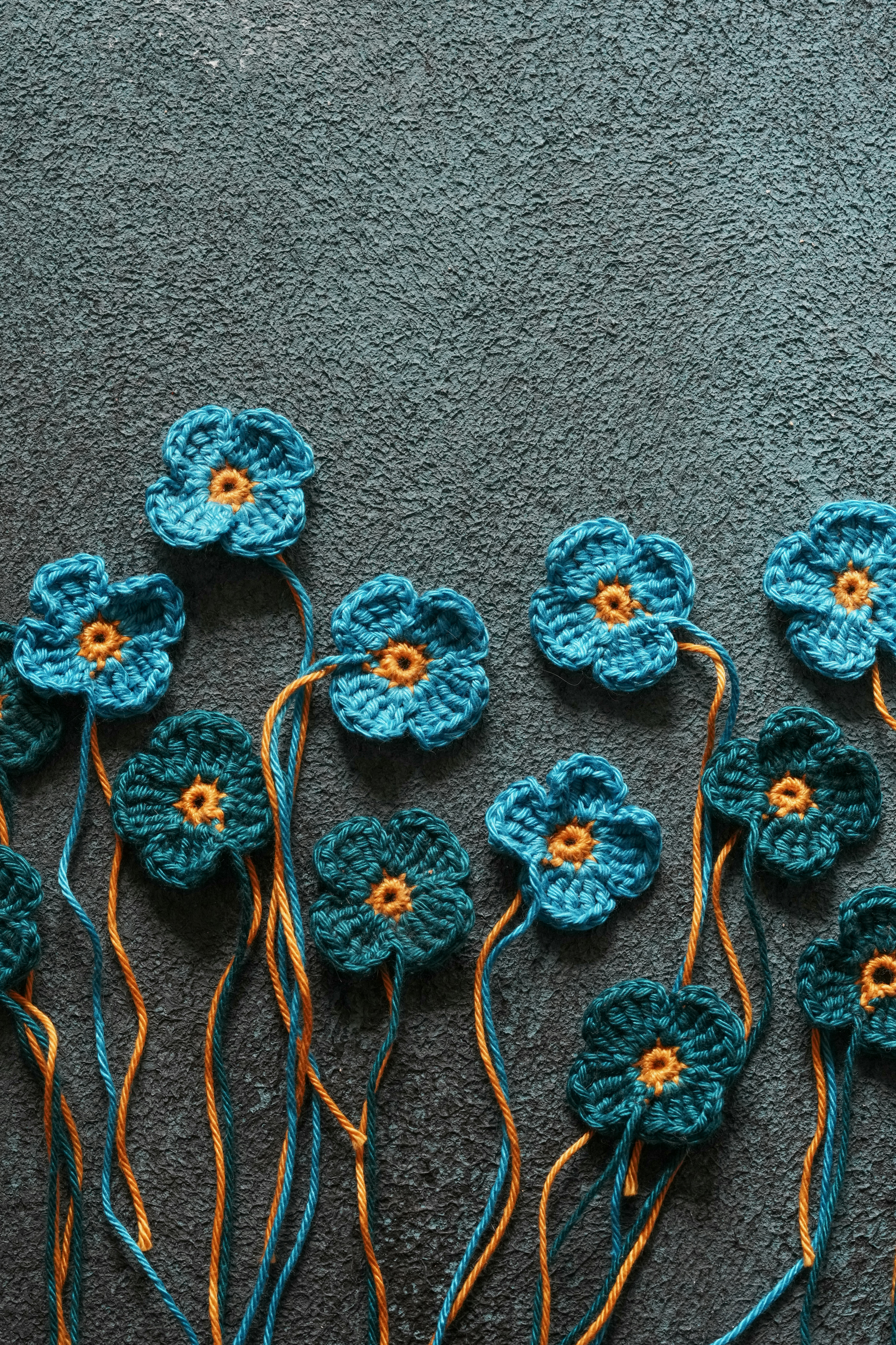 a group of crocheted flowers sitting on top of a carpet