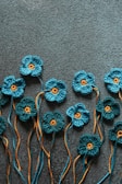 a group of crocheted flowers sitting on top of a carpet