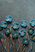 a group of crocheted flowers sitting on top of a carpet