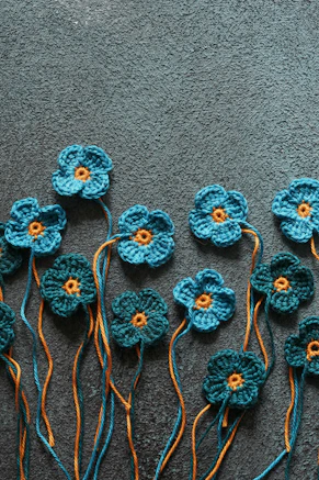 a group of crocheted flowers sitting on top of a carpet