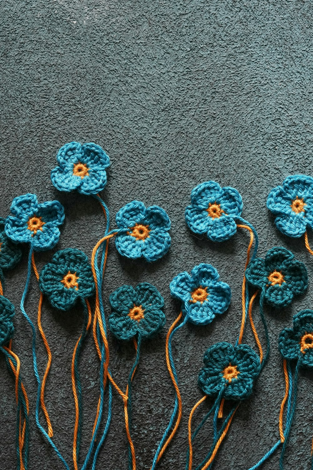 a group of crocheted flowers sitting on top of a carpet