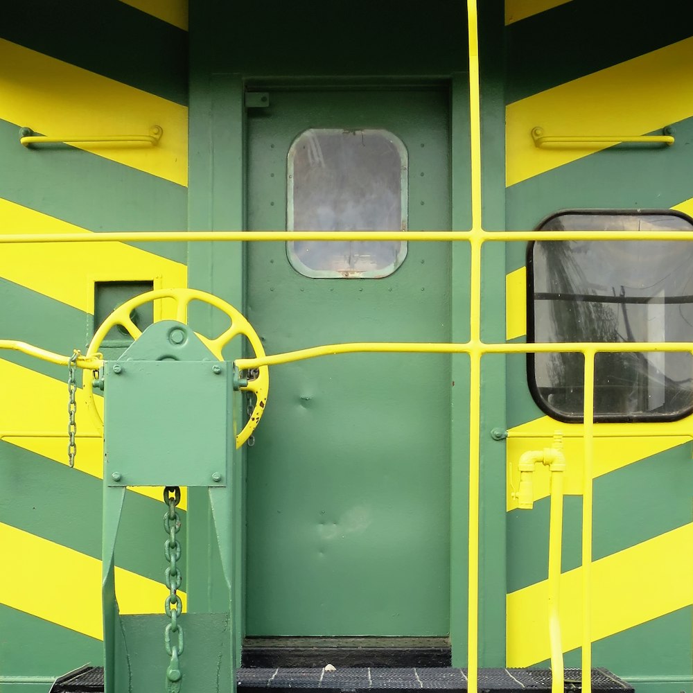 the door of a green and yellow train