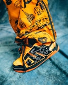 Close-up of a Labubus sneaker with colorful street art behind.