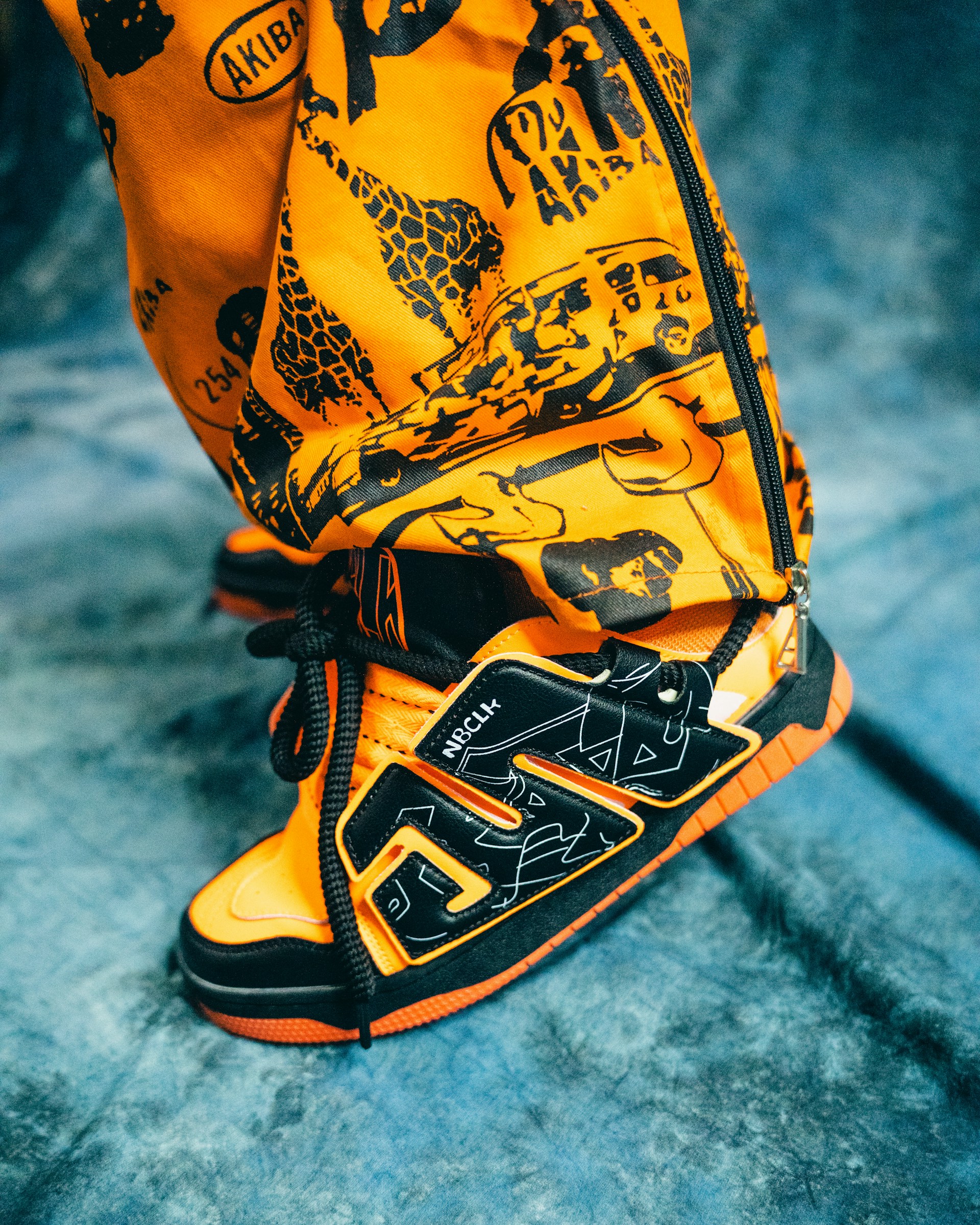 A close-up shot of stylish urban sneakers on a graffiti-covered wall background, highlighting texture and vibrant colors.