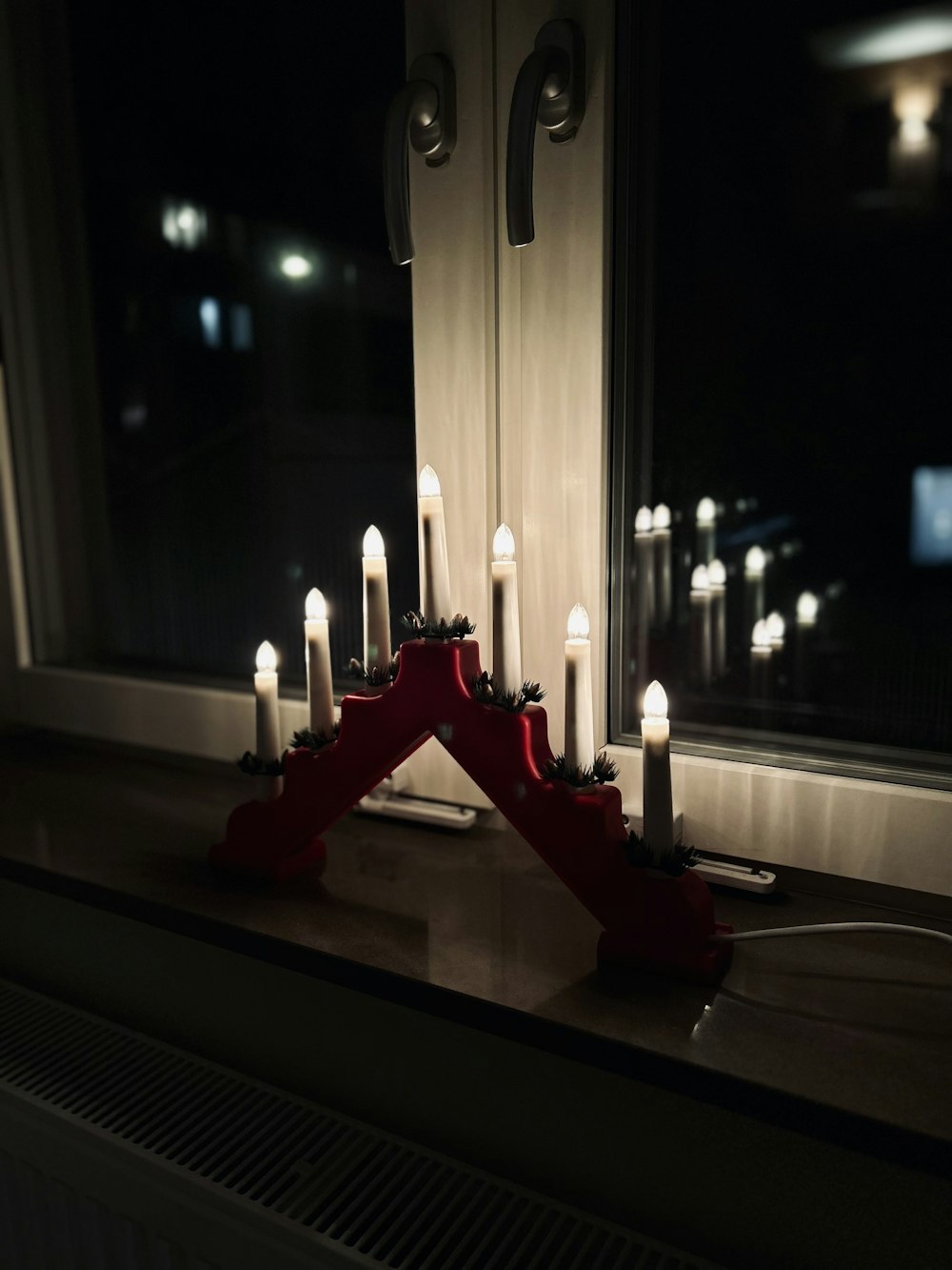 a group of candles sitting on top of a window sill