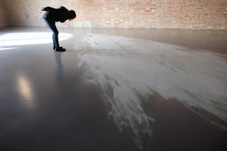 Close-up of a smooth, glossy epoxy floor reflecting soft natural light.