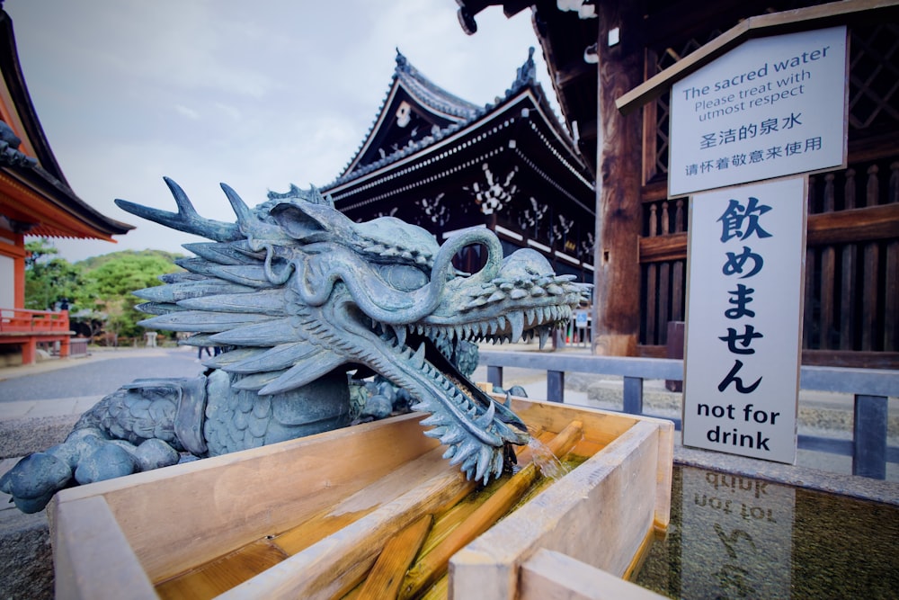 a statue of a dragon in front of a building