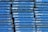 A stack of blue wooden pallets marked with the brand name 'CHEP' in white letters. Each pallet is uniformly colored and arranged tightly together, forming a repetitive pattern.