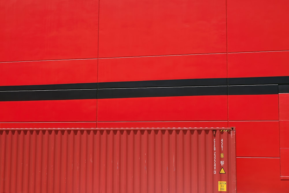 a red building with a black stripe on the side