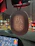 Close-up of a sleek marocmerch car air freshener hanging from a rearview mirror.