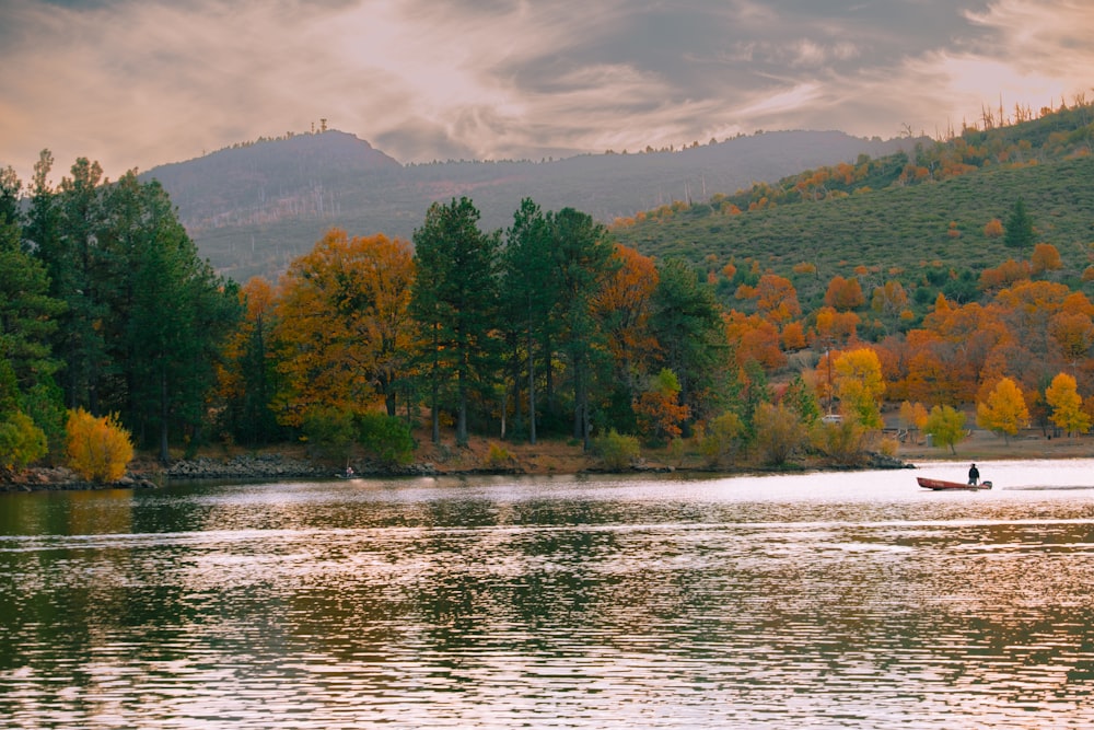 a person in a small boat on a lake