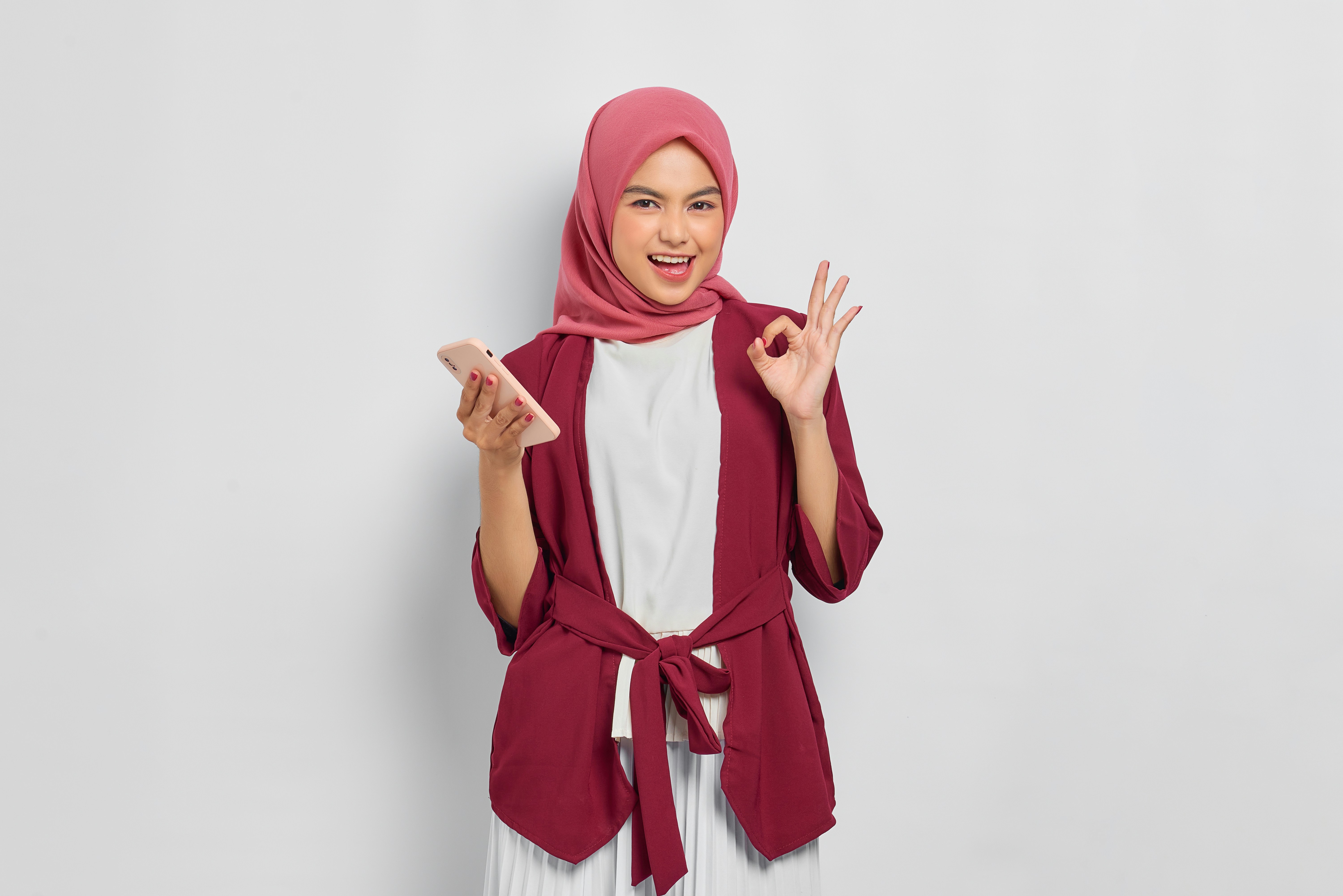 a woman in a hijab is making a peace sign