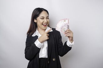 a woman holding a bunch of money in her hands