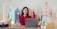 A happy woman holding job offer papers with a smile in an office setting.
