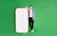 A person stands confidently against a bright green background, leaning on a large, blank smartphone cutout with a red-orange border. They are casually dressed in a blue shirt, white t-shirt, black pants, and white sneakers, and display a positive demeanor.
