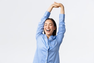 a woman with her arms in the air
