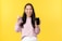 A happy woman holding a smartphone with reward notifications on the screen.
