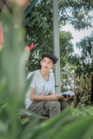A calming scene of a person reading a wellness e-book outdoors in nature.