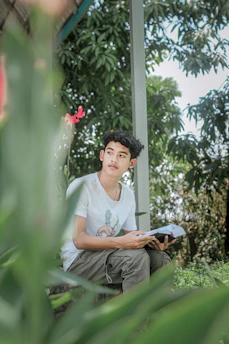 Person listening to an audiobook with headphones, surrounded by calming nature