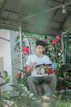 Confident young man reading a book outdoors in a park.
