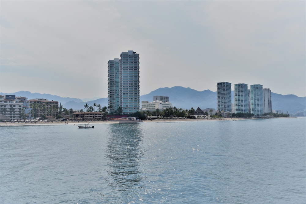 a body of water with buildings in the background