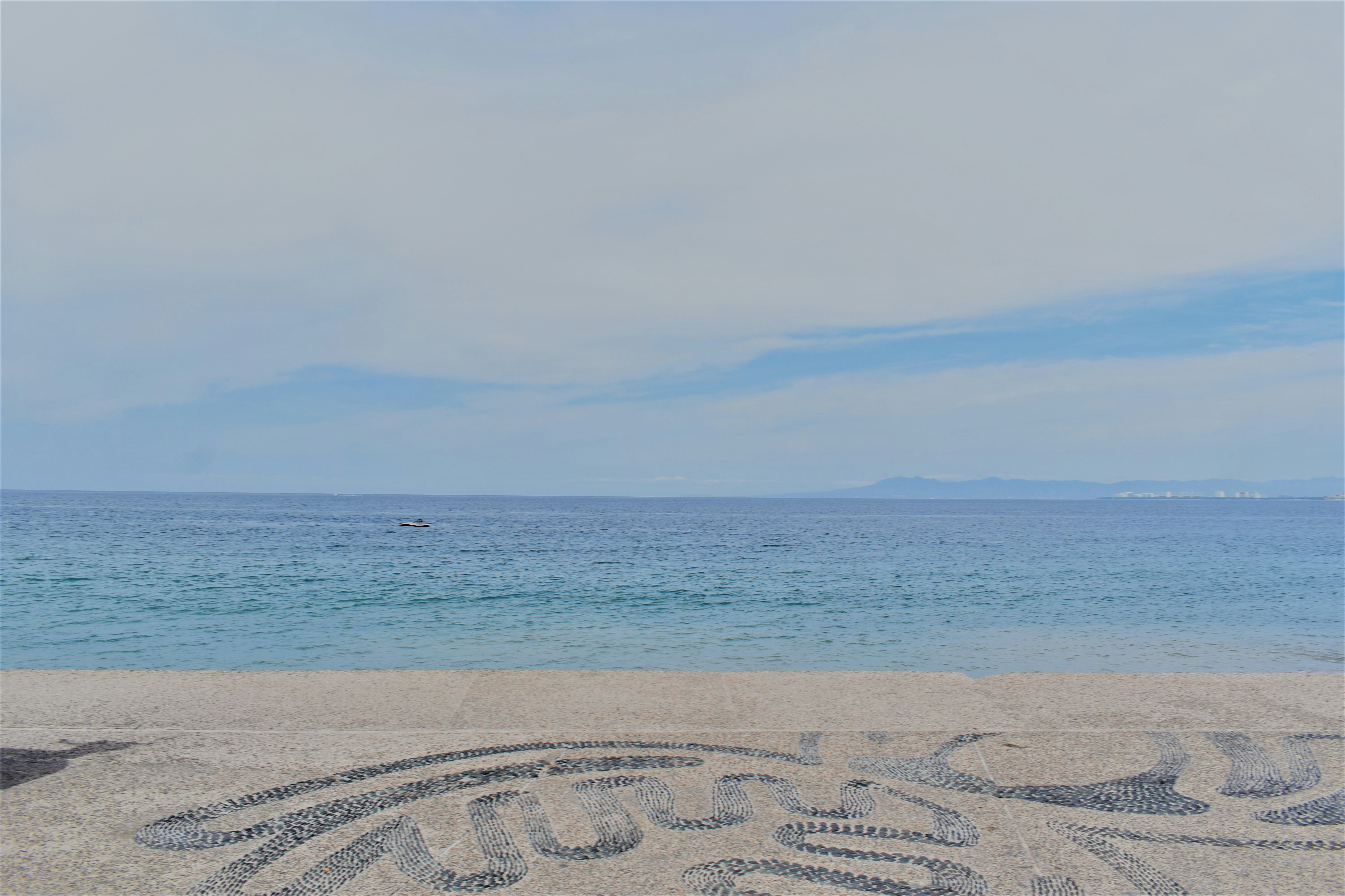 a person sitting on a beach next to the ocean