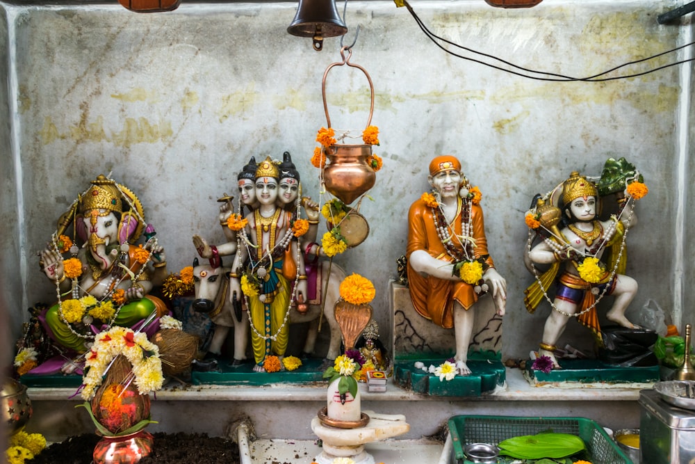 a group of statues sitting on top of a shelf