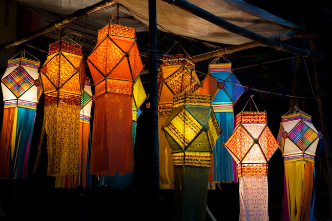 a group of colorful umbrellas hanging from a pole