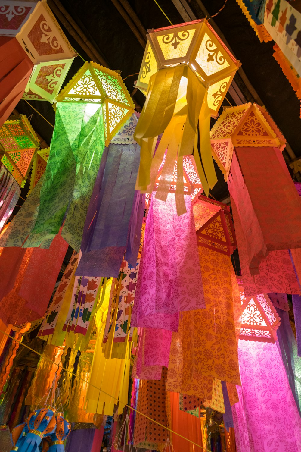 a bunch of colorful lights hanging from a ceiling