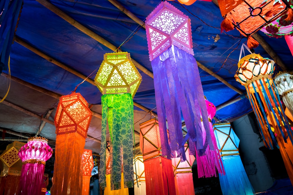 a group of colorful lights hanging from a ceiling