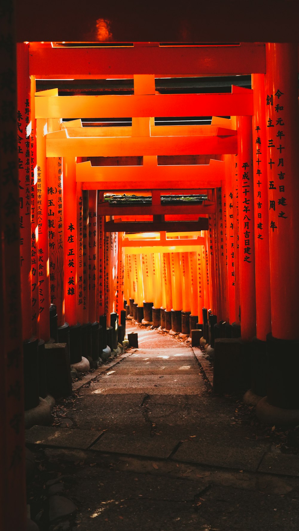 a tunnel of red lanterns in a city