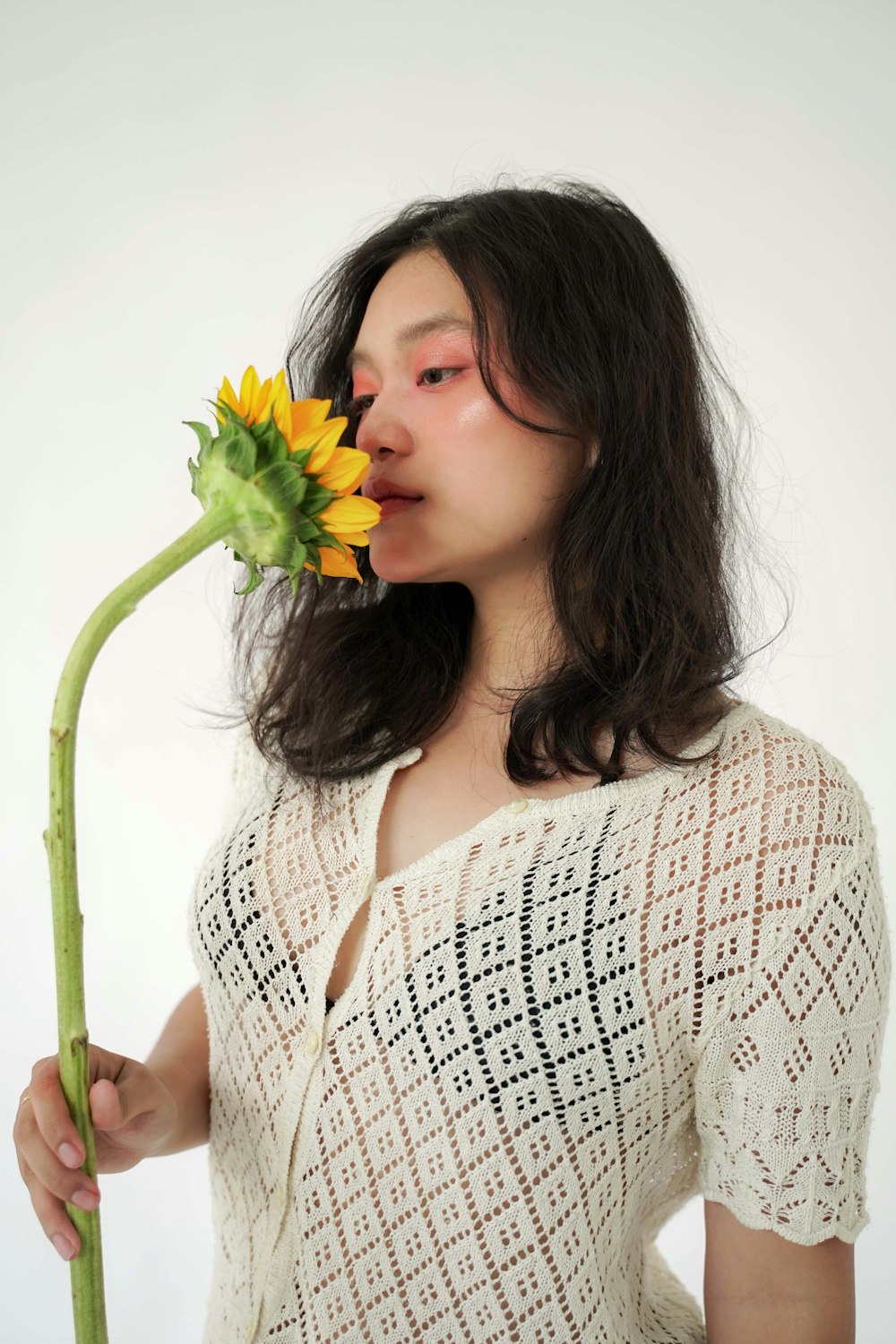 a woman with a flower in her mouth