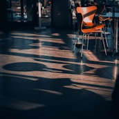 soft natural light casting shadows on a modernist architectural model with deep emerald accents.