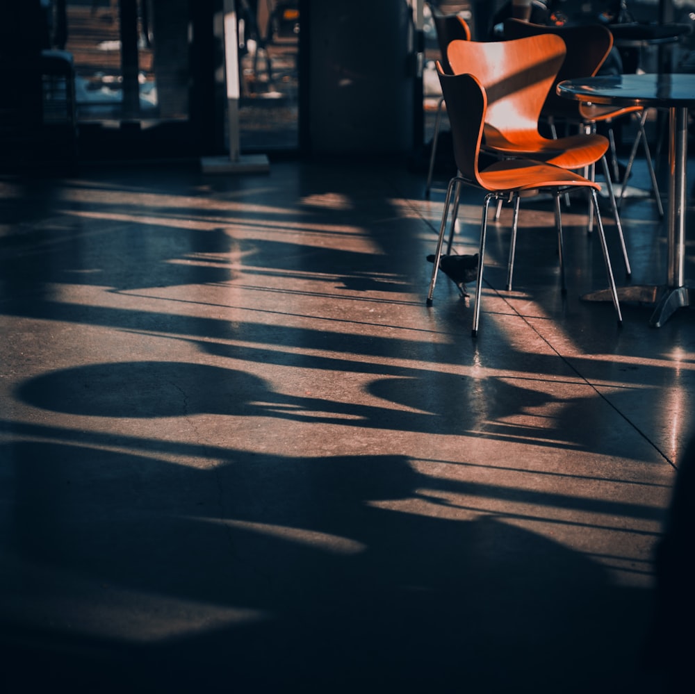 an orange chair sitting on top of a hard wood floor