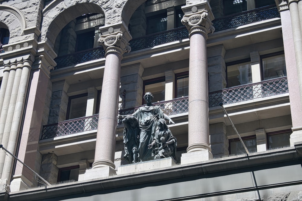 a statue of a man on a horse in front of a building