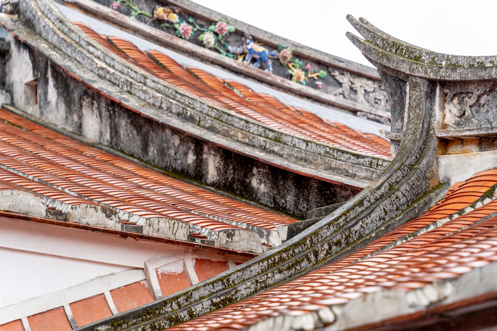 a close up of a roof with a bird sitting on top of it