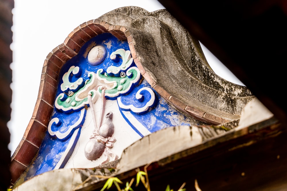 a close up of a blue and white clock on a building