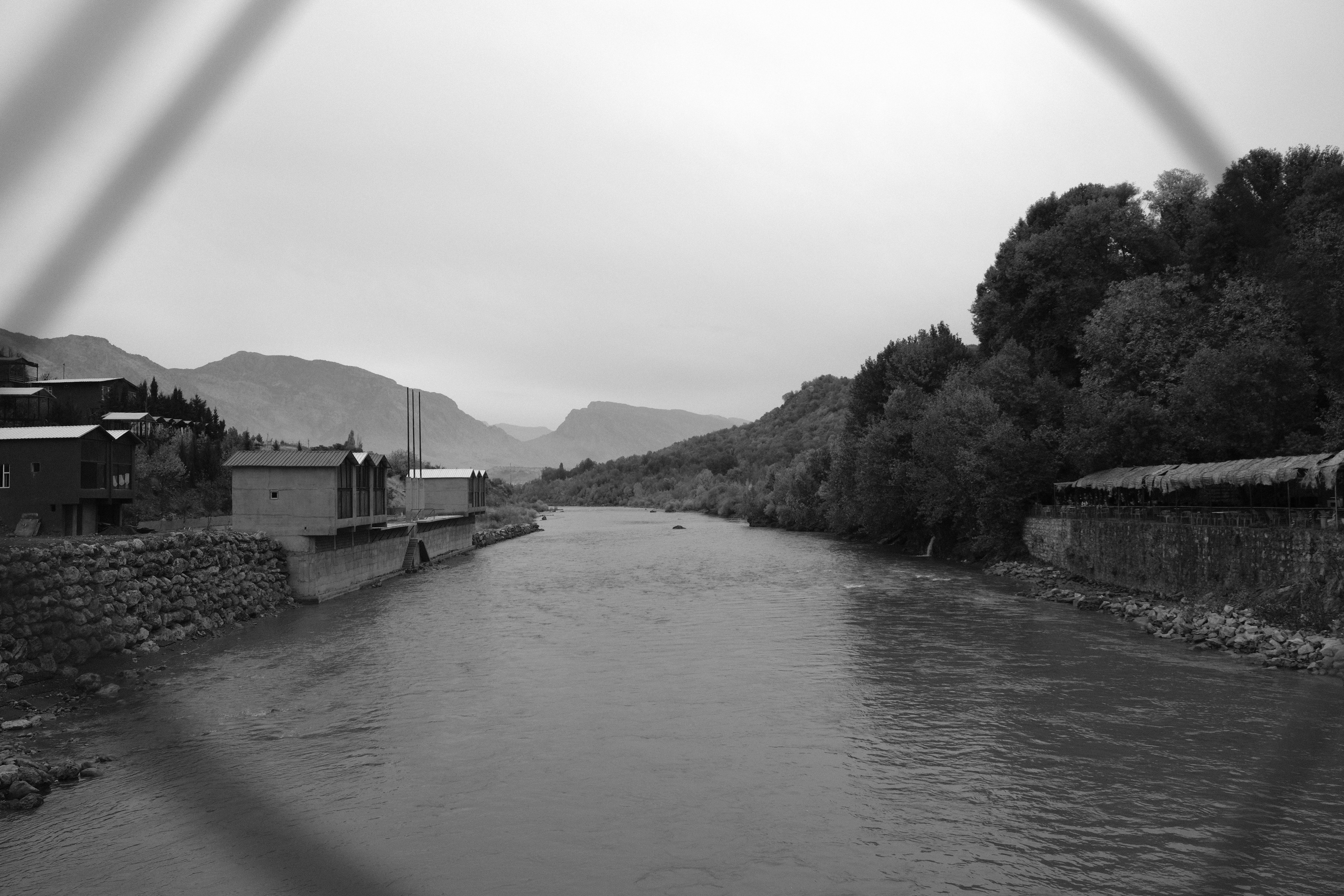 a black and white photo of a river