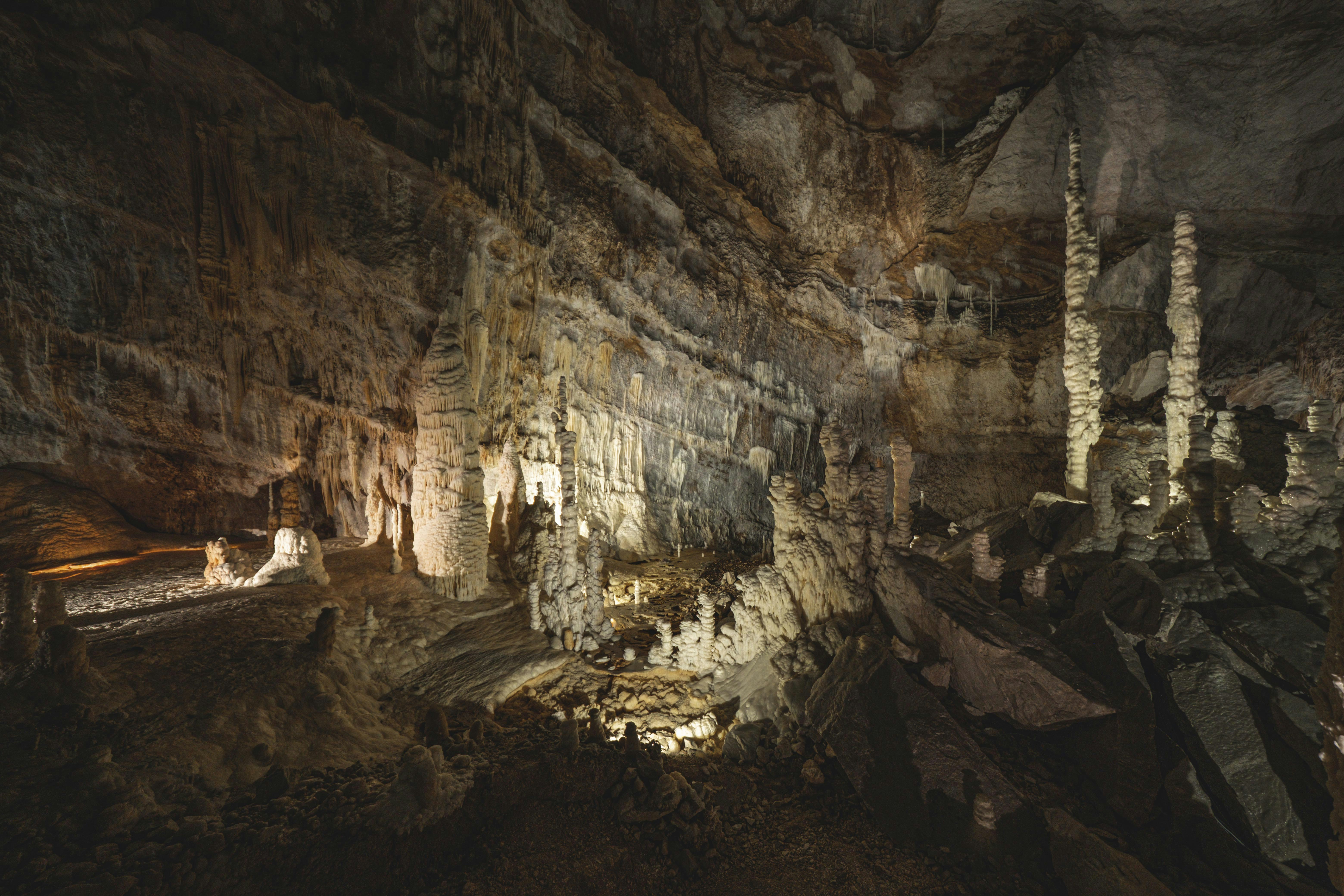a group of people standing inside of a cave