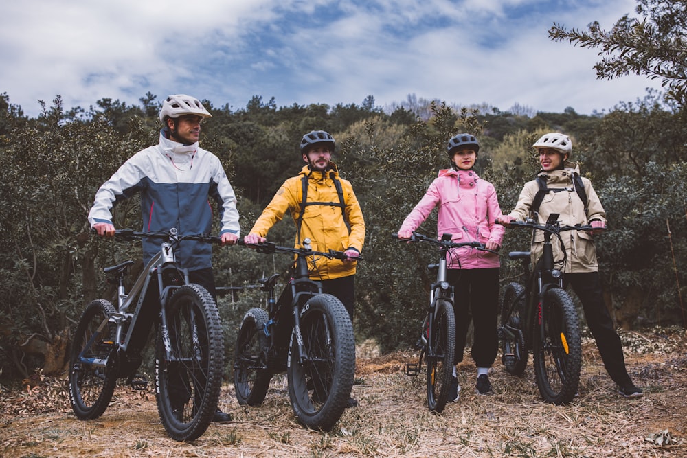 a group of people standing next to each other on bikes