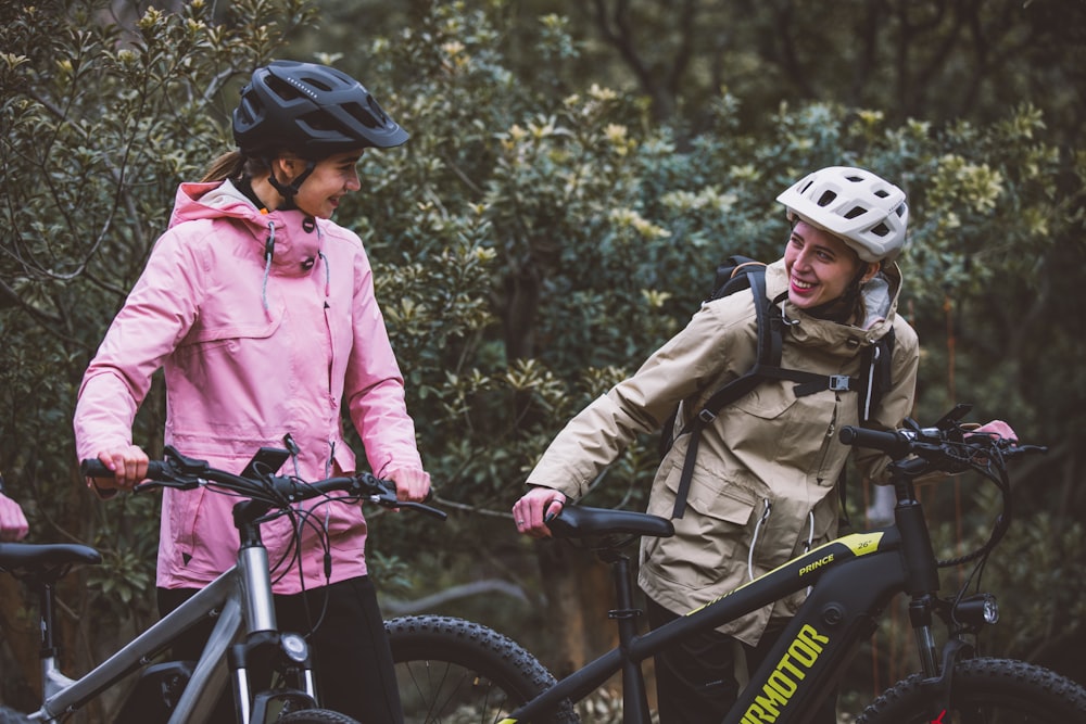 a man and a woman standing next to their bikes