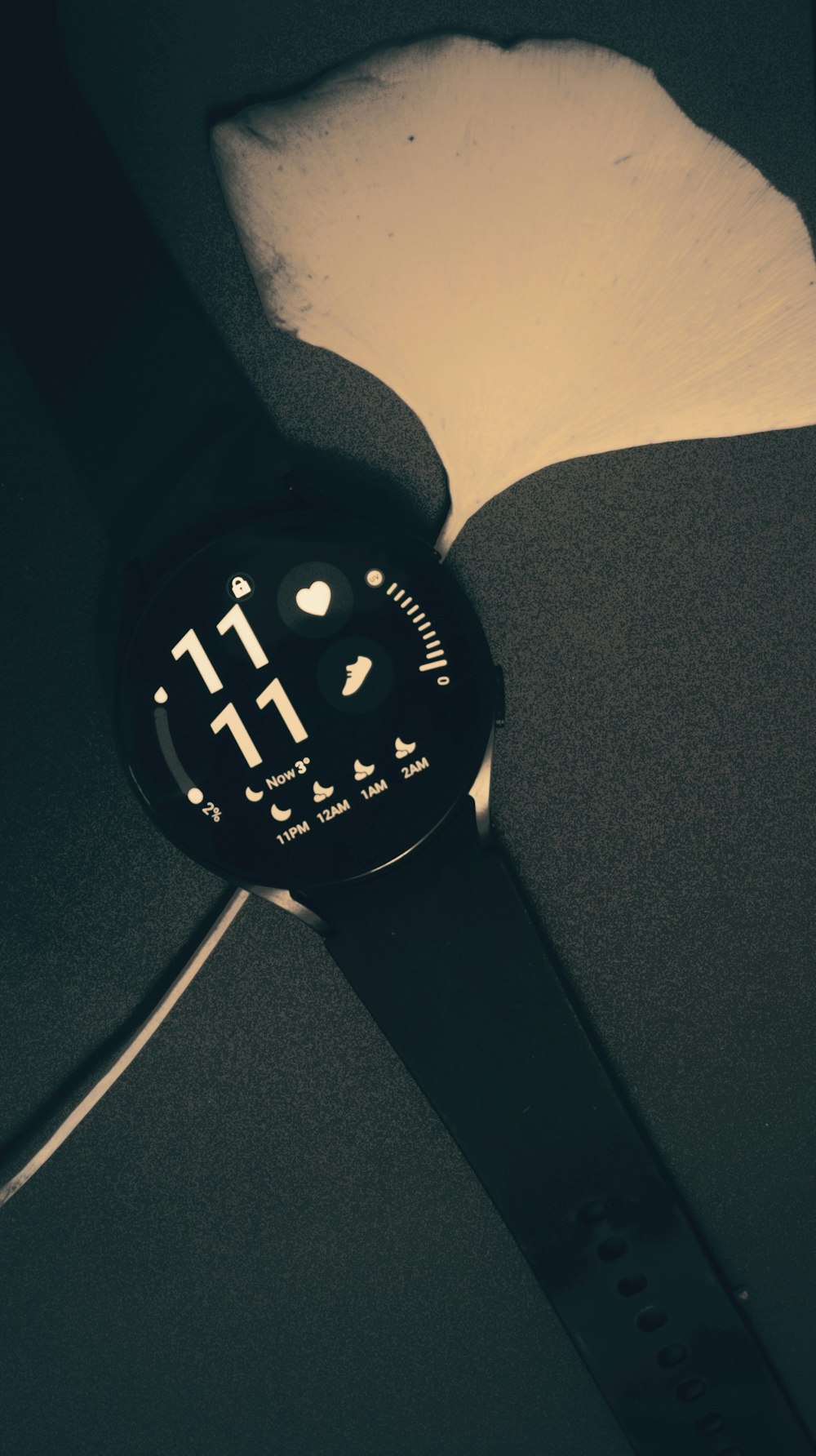 a watch is sitting on a black surface