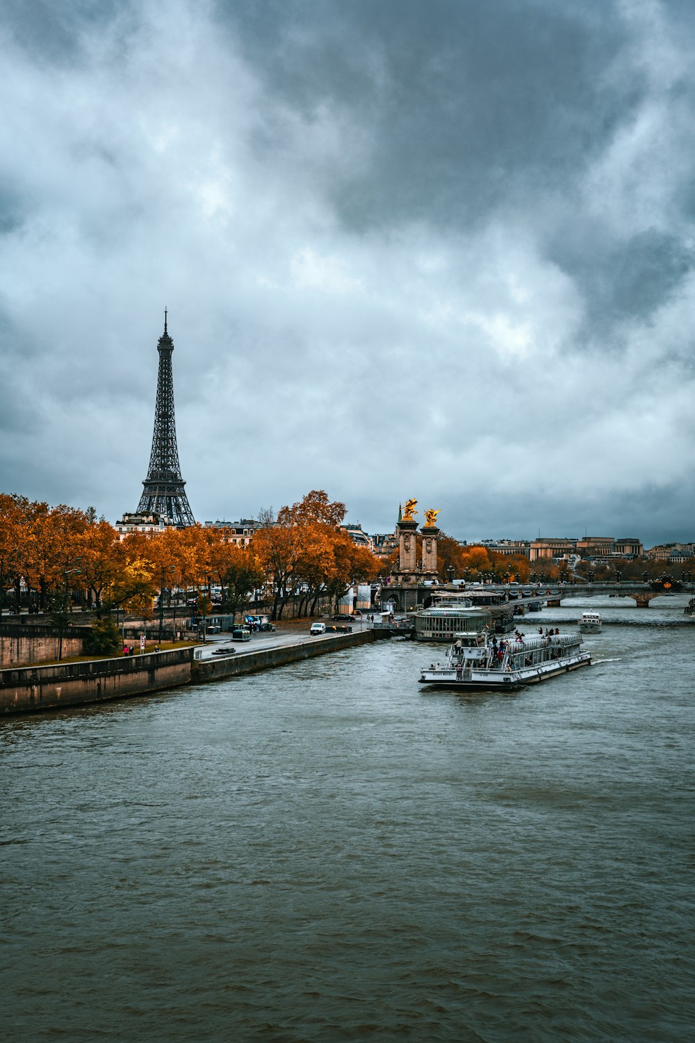 a river with boats and a tower in the background